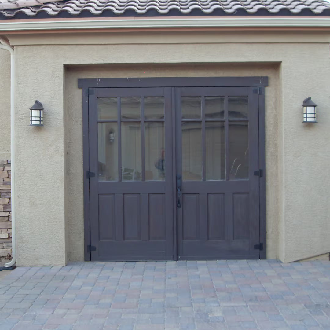 Carriage-style door with elongated glass panels, shown on a retail storefront exterior with a modern, minimalist design in daylight.