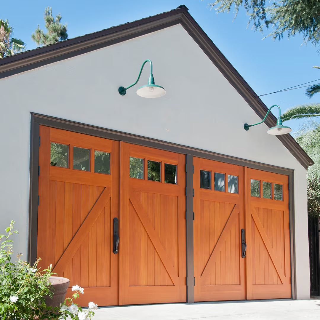 Double carriage garage doors with classic Z-brace detailing, installed on a residential exterior in natural daylight.