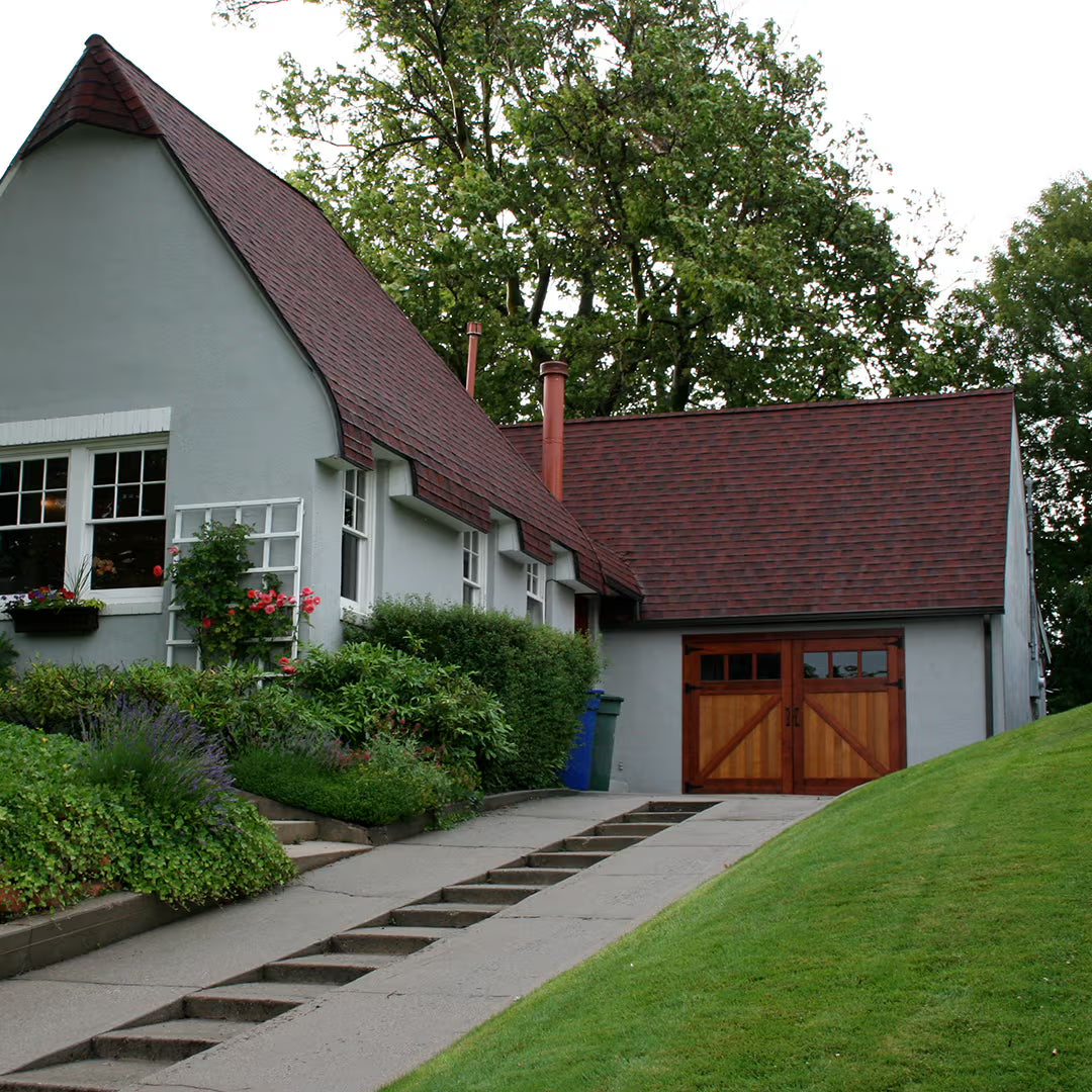 Low-clearance Z-brace carriage garage door installed on a residential exterior, shown in daylight with a reduced vertical opening.