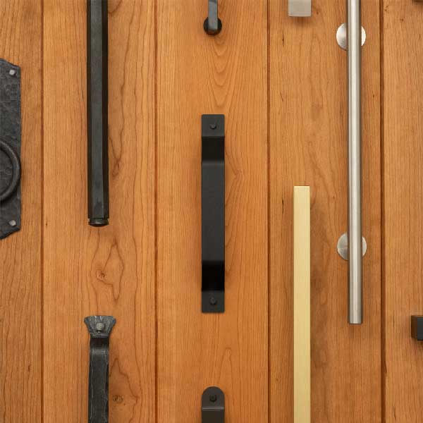 Closeup photo of specialty handles on wood plank board. 