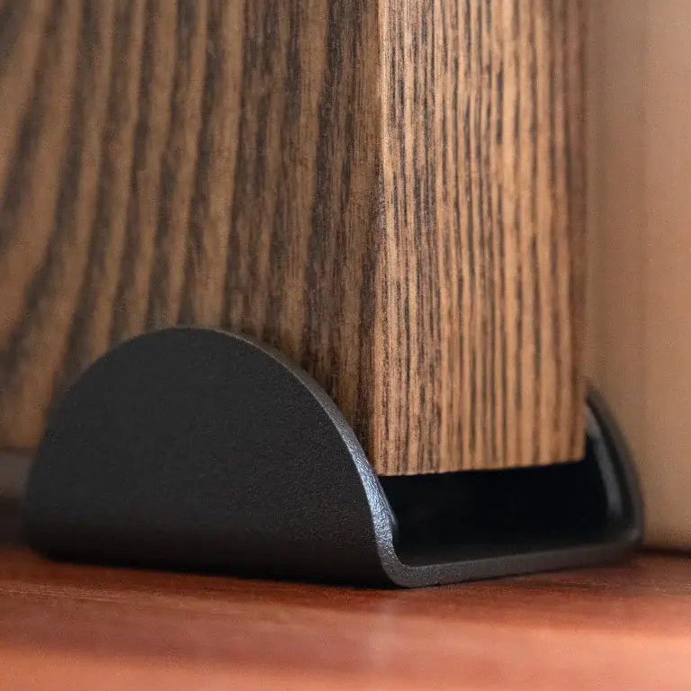 Black furniture leg on a wooden surface