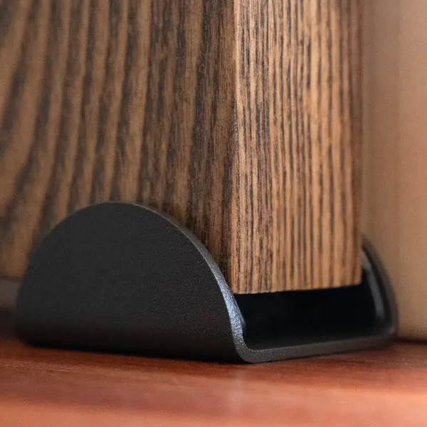 Black furniture leg on a wooden surface