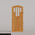 Murano arched door in Tight Knot Cedar, with four upper glass panels and a grid of wood panels. Labeled wood species view.
