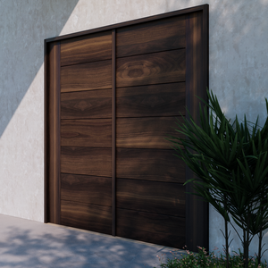 Moidern walnut wood carriage style garage door next to a palm plant