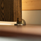 steel door stop against the edge of a wood door