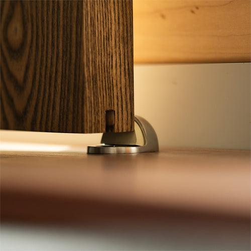 steel door stop against the edge of a wood door