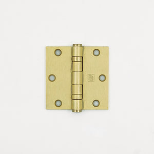 Brass door hinge on a white background
