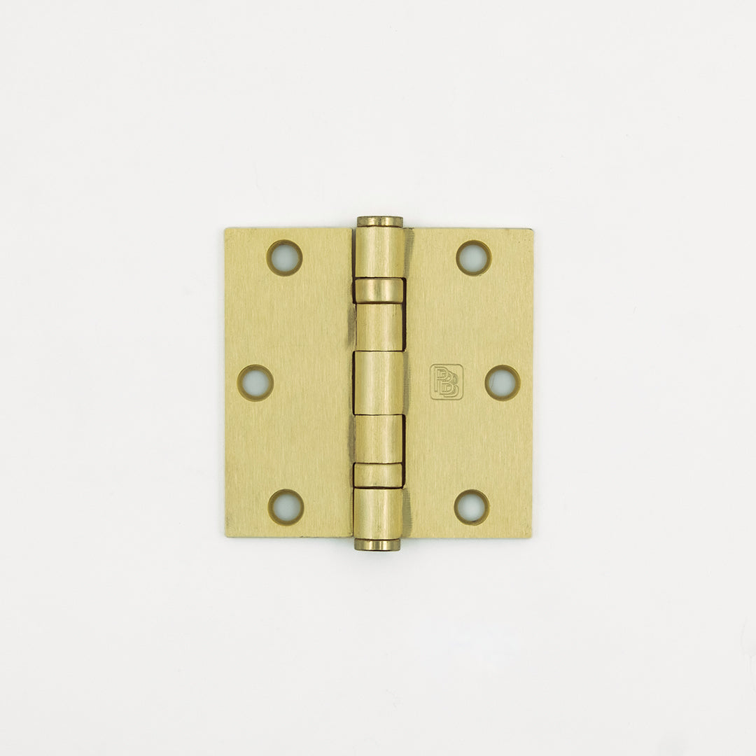Brass door hinge on a white background