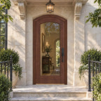 RealCraft Amalfi arched door in Black Walnut, beneath a projecting stone canopy with a hanging lantern.