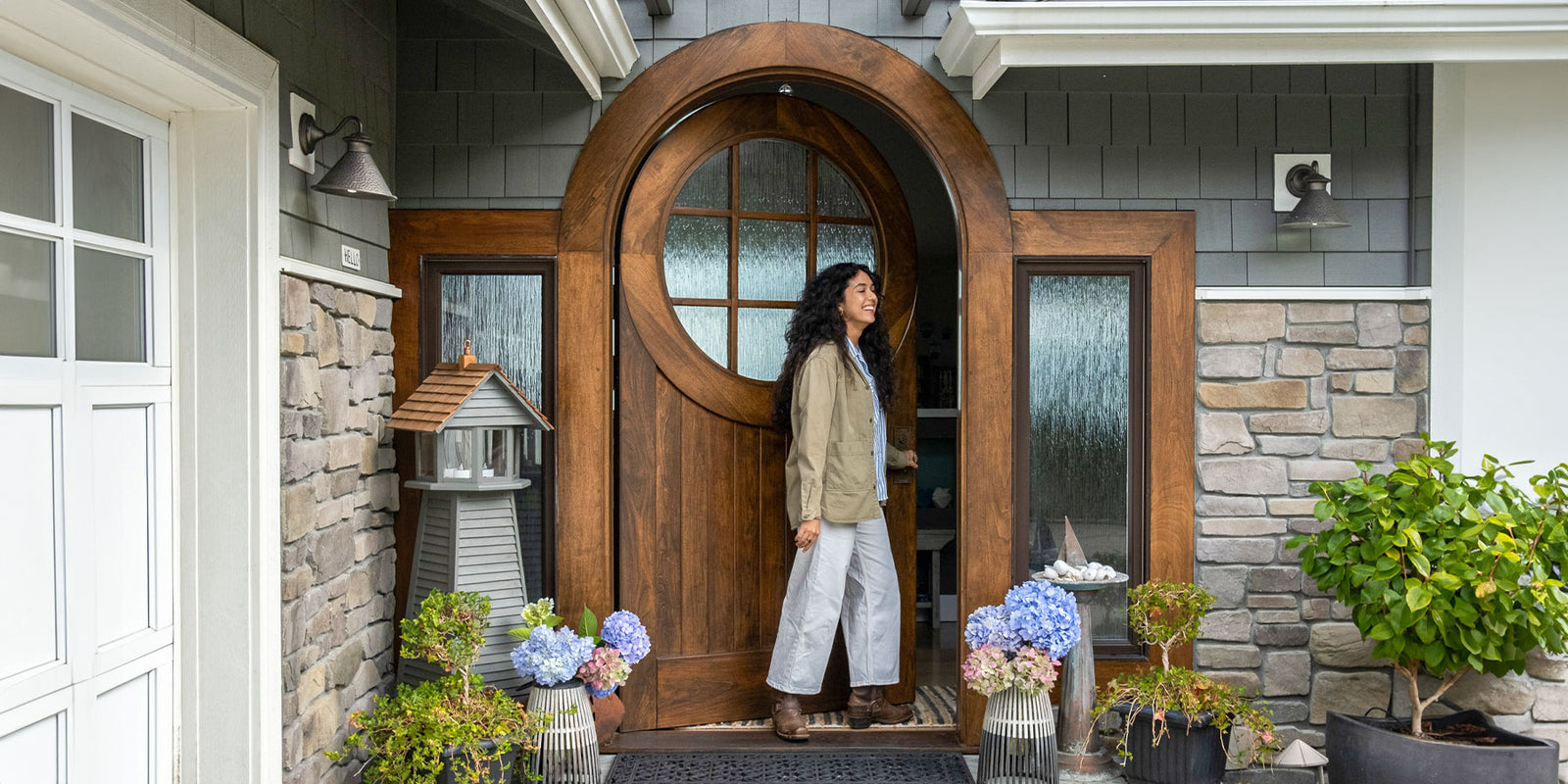 woman opening walnut round top door
