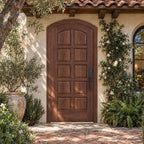 RealCraft Firenze arched door in Black Walnut, shown beneath a projecting roof overhang in a Mediterranean courtyard.