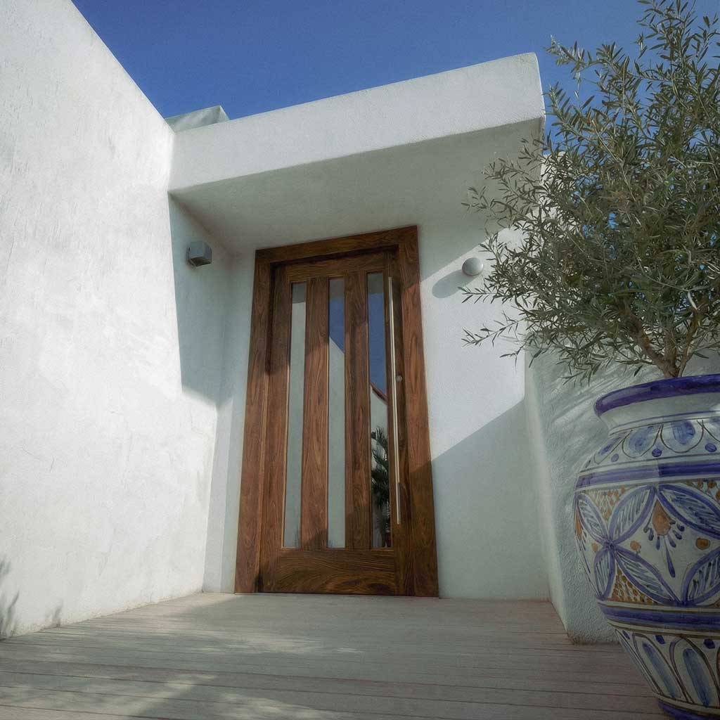 Wooden door on a white wall with a decorative plant pot in the foreground