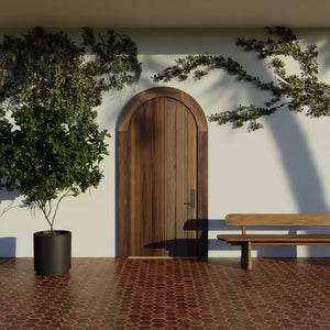 Flush Plank Round Top Door with matching casing in Black Walnut on modern home with climbing vines 