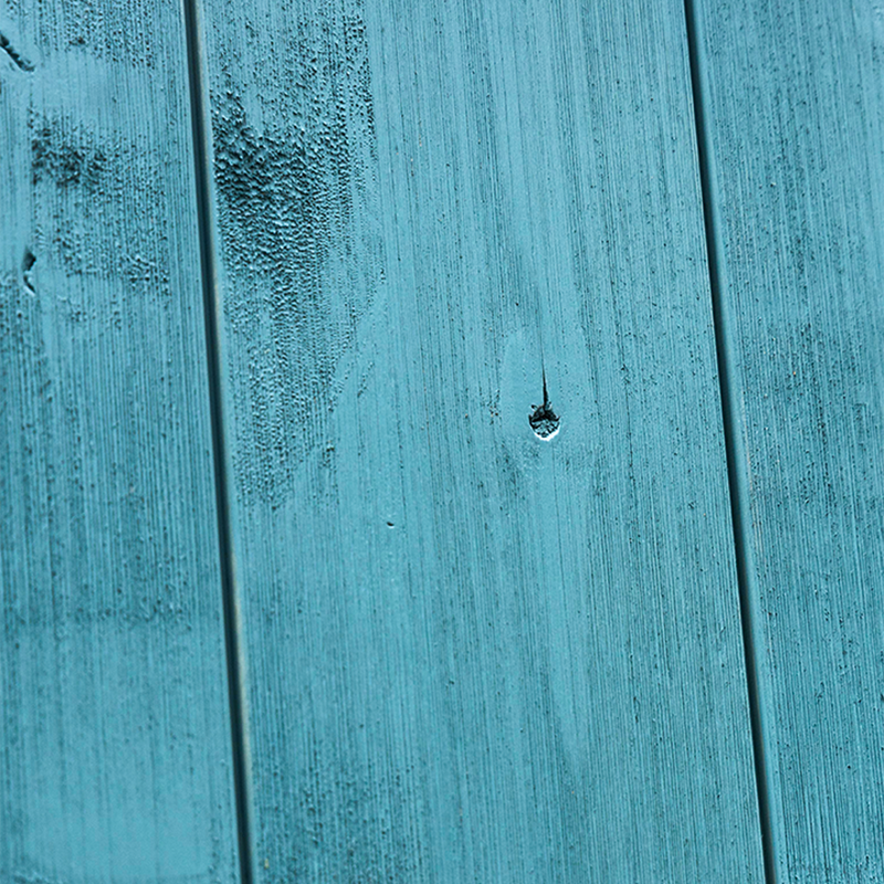 Blue weathered wood barn door closeup 