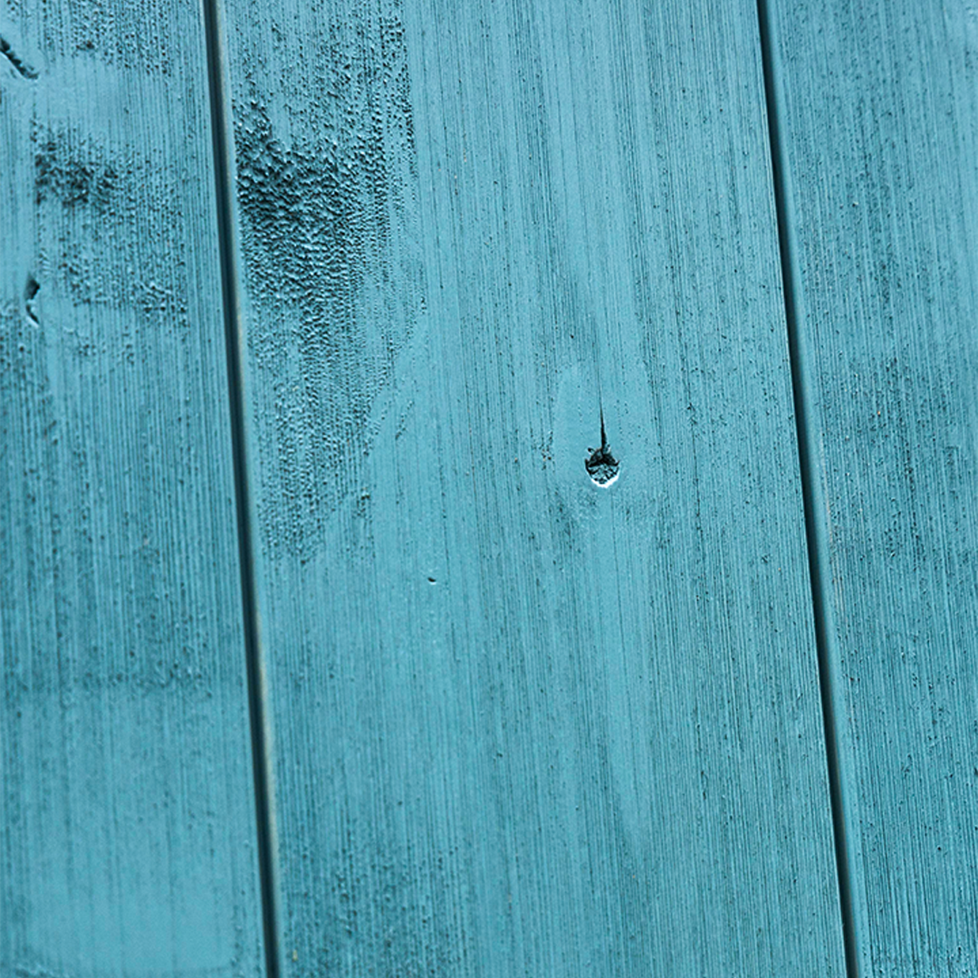Blue weathered wood barn door closeup 
