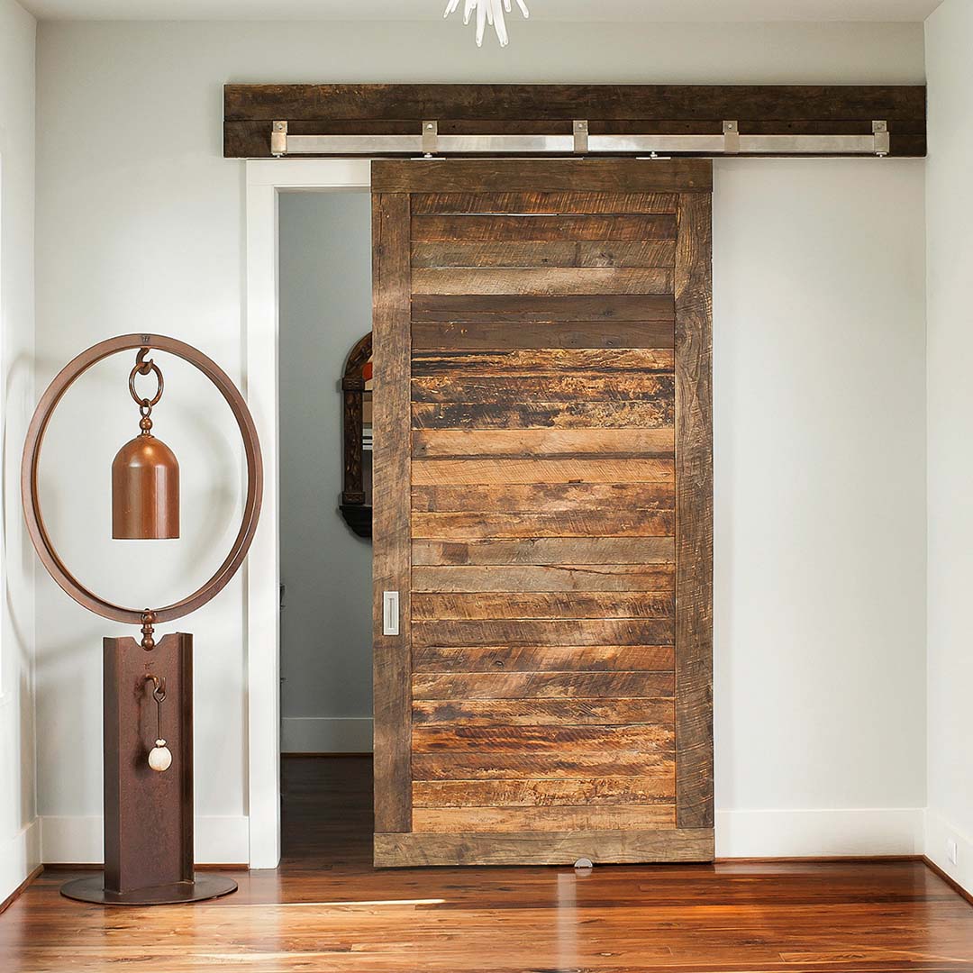 Box Rail Barn Door hardware installed on reclaimed wood door in a living space