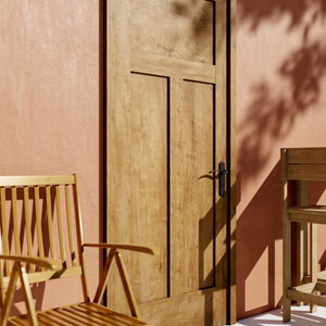 Shaker High-T Solid Core Exterior Front Door on a orange plaster wall